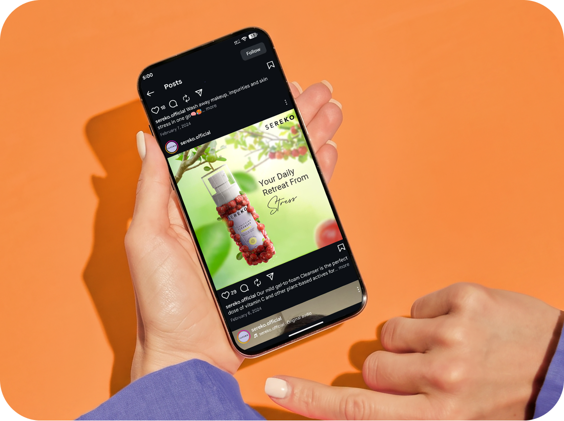 Sereko “Your Daily Retreat From Stress” Instagram post open on a phone held over an orange backdrop