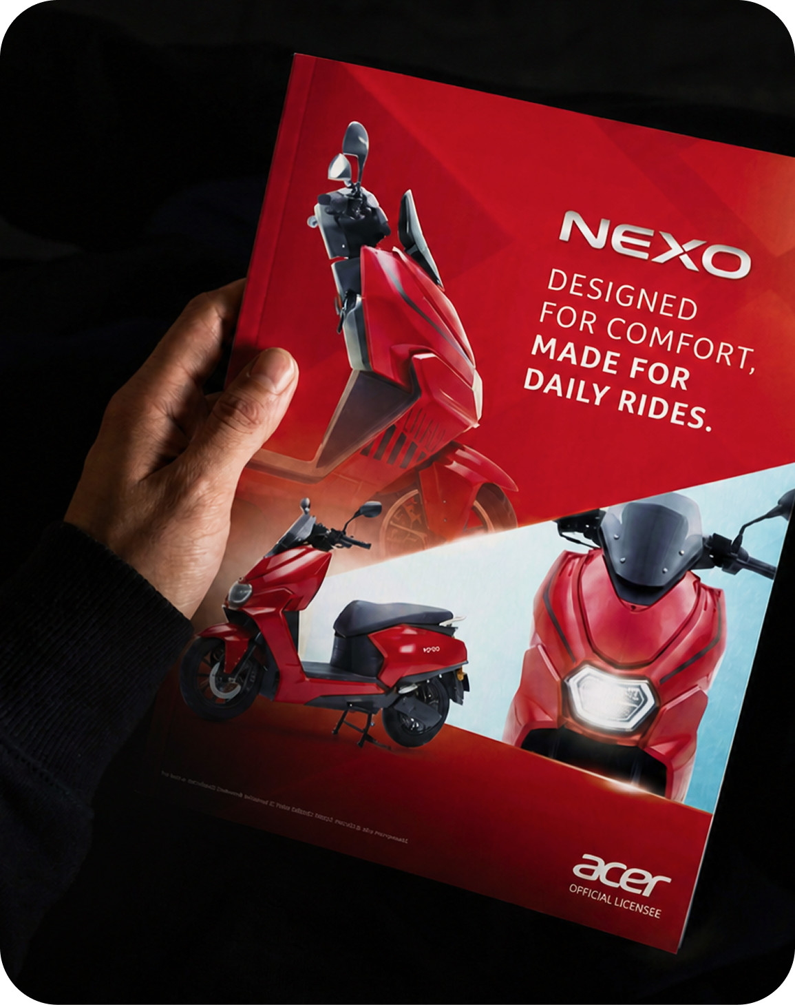 Printed NEXO electric scooter brochure for Acer held in low light